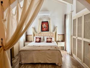 a bedroom with a large bed with a canopy at Mon Ilıca Otel in Çeşme