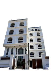 un edificio alto de color blanco con muchas ventanas en Ranisa Kampot, en Kampot