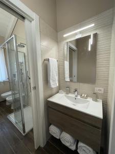 a bathroom with a sink and a shower and a toilet at Attico 800 in Castiglion Fosco +61 photos