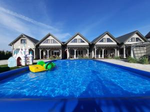 a swimming pool in front of a house at Holiday Homes 777 in Karwia +48 photos
