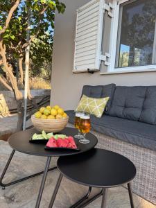 a table with a bowl of fruit and a glass of wine at Casa Negiada in Agios Nikolaos