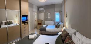 a hotel room with two beds and a mirror at Casa Negiada in Agios Nikolaos