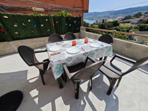 a table and chairs on a patio with a view at Casa Buro in Bueu
