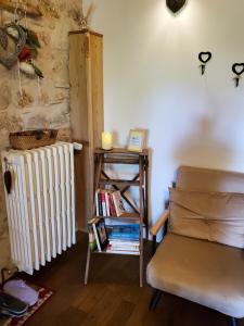 a living room with a radiator and a chair at chez Karine in Ceyzérieu