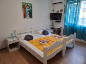 a bedroom with a bed with two towels on it at Joković Accommodation in Kotor