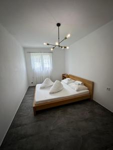 a bedroom with a bed and a chandelier at Apartment Oberleins III in Arzl im Pitztal
