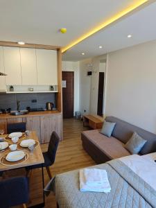 a living room with a couch and a table at Harmony, Residence Hill A85 in Kopaonik