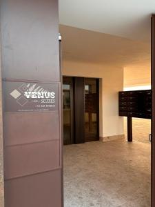 an entrance to a building with a sign on the door at Venus Suites in Bari