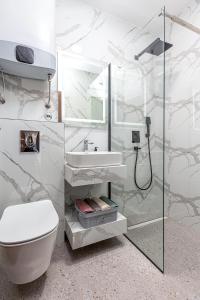 a bathroom with a toilet and a sink and a shower at Adriatic Residence in Budva