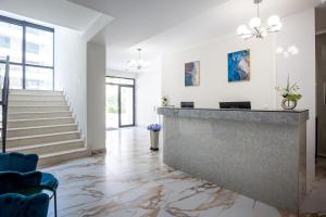 a lobby with a reception counter and stairs at Adriatic Residence in Budva