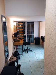 a room with a desk and chairs in a room at Apartment in a house among three beaches in Sutomore +6 photos