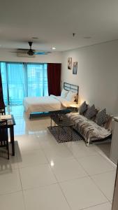 吉隆坡Summer Suites KLCC by CozyNest的一间卧室配有两张床和一张沙发。