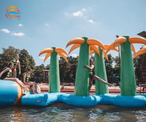 a group of children jumping off an inflatable raft in the water at Zacisze Bis in Koszelówka