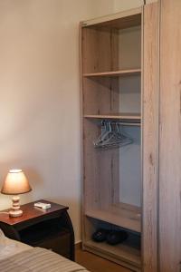 a bedroom with a wooden closet with shoes in it at Olive Scent in Gouves