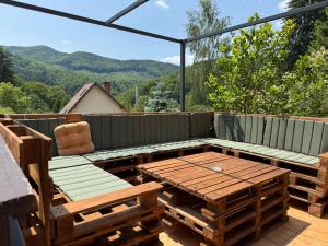 a patio with a table and chairs on a deck at Villa Garden Balvanyos in Turia