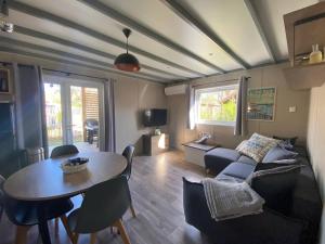 a living room with a couch and a table at Bassin d'Arcachon - Chalet VIP 5 personnes in La Teste-de-Buch
