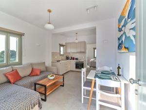 a living room with a couch and a table at Ilios 2 Apartment Paros Naousa in Naousa