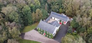 an aerial view of a large house in the forest at The Gallery Cottage in Castledawson
