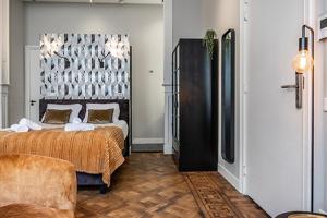 a bedroom with a bed and a couch in it at City Center Located City Villa Tilburg Alexander in Tilburg