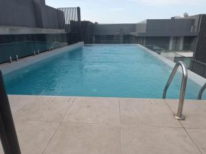 a swimming pool on the roof of a building at Nova luxe 2 Bed Executive Stay in Accra
