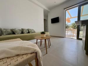 a living room with a couch and a table at The Kalymnos Cliff Apartments in Kalymnos