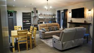 a living room with a couch and a table at The Gallery Cottage in Castledawson