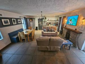 a living room with a couch and a fireplace at The Gallery Cottage in Castledawson
