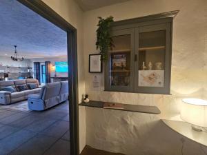 a living room with a couch and a table at The Gallery Cottage in Castledawson