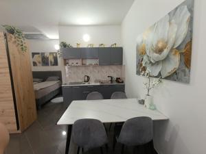 a kitchen and living room with a table and chairs at Relax 2 in Bosanska Dubica