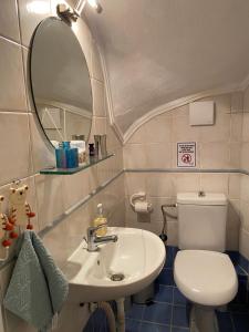 a bathroom with a toilet and a sink and a mirror at Daylight in Nea Skioni