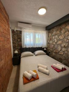 a bedroom with a large bed with towels on it at Beachfront Villa Amfora with Pool in Karlobag