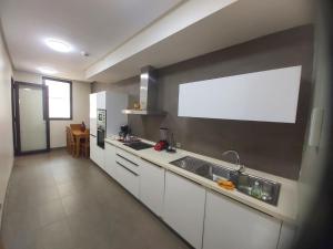 a kitchen with a sink and a large window at Ocean View Apartment - Anfa Place - in Casablanca