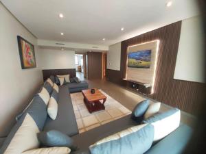 a living room with a couch and a table at Ocean View Apartment - Anfa Place - in Casablanca