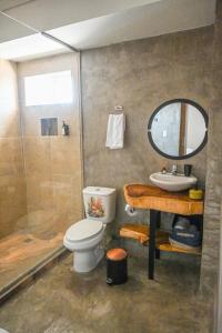 a bathroom with a toilet and a sink and a shower at Hotel Bahía Azul Manga Cartagena in Cartagena de Indias