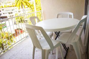 a white table and chairs on a balcony at Hotel Sands Acapulco in Acapulco