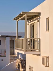 a balcony of a house with a wooden deck at Ilios 2 Apartment Paros Naousa in Naousa