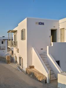 a white building with stairs on the side of it at Ilios 2 Apartment Paros Naousa in Naousa