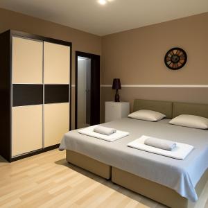 a bedroom with a large bed with two white pillows at Struga Rooms-Dhoma-Sobi in Struga