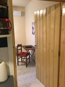 a door leading into a room with a table at Lidas Sunny Guest House Argolis in Nafplio