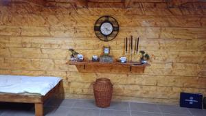 a room with a wooden wall with a clock on it at CAMP Odmaraliste PURISIC in Plav +23 photos
