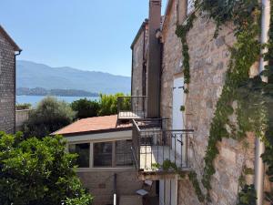 a house with two balconies on the side of it at Private double room in the Old Town in Budva