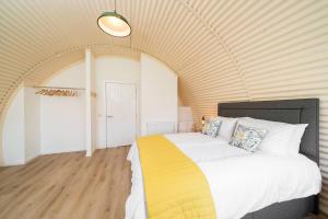 a bedroom with a large bed in a room at Cultybraggan Hut 34 in Mill of Fortune