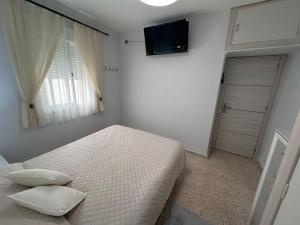 Ένα ή περισσότερα κρεβάτια σε δωμάτιο στο Chipiona playa +7 φωτογραφίες