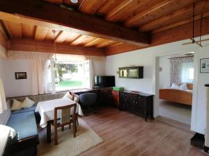 a living room with a table and a bedroom at Haus Grünwald in Gosau