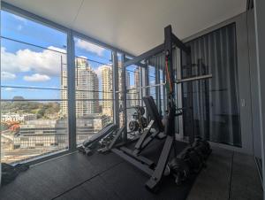 a gym with a view of a city at Ultra Luxury 1BR with Study beside Crown Sydney, with All AMENITIES! And sleeps 4! in Sydney