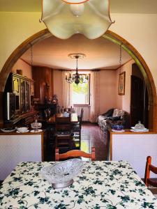 a living room with a table and a dining room at Il Giardino di Monterole Cà d'Pini in Bagnone