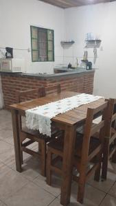 a wooden table and chairs in a kitchen at Casa quase frente a Rodoviária in Corumbá