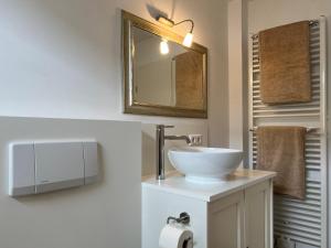 a bathroom with a sink and a mirror at Ferienwohnung Bodenseeparadies in Friedrichshafen +17 photos