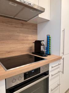 a kitchen with a stove and a microwave at Ferienwohnung Bodenseeparadies in Friedrichshafen
