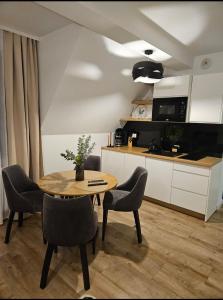 a kitchen with a table and chairs in a room at Apartament Ruczaj in Białka Tatrzanska